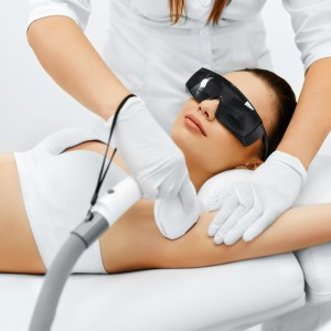 Body Care. Underarm Laser Hair Removal. Beautician Removing Hair Of Young Woman's Armpit. Laser Epilation Treatment In Cosmetic Beauty Clinic. Hairless Smooth And Soft Skin. Health And Beauty Concept.