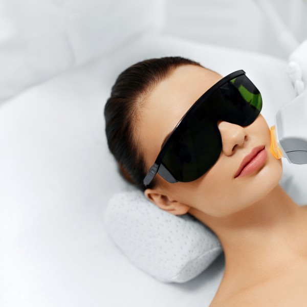 Skin Care. Young Woman Receiving Facial Beauty Treatment, Removing Pigmentation At Cosmetic Clinic. Intense Pulsed Light Therapy. IPL. Rejuvenation, Photo Facial Therapy. Anti-aging Procedures.